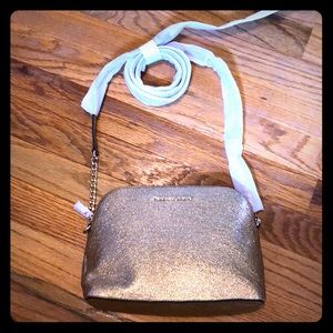 Brand new with tags.Gold leather cross body.